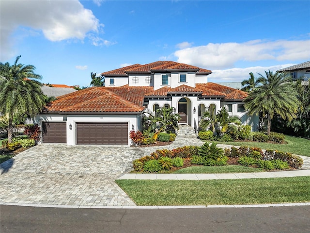 mediterranean / spanish home with a garage