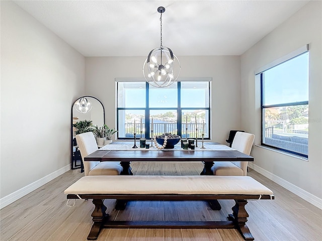 dining room with a notable chandelier and light wood-type flooring