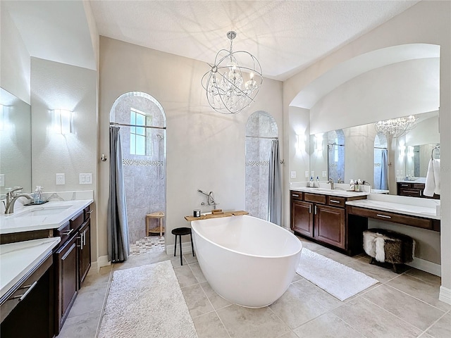 bathroom featuring vanity, a chandelier, shower with separate bathtub, and tile patterned flooring