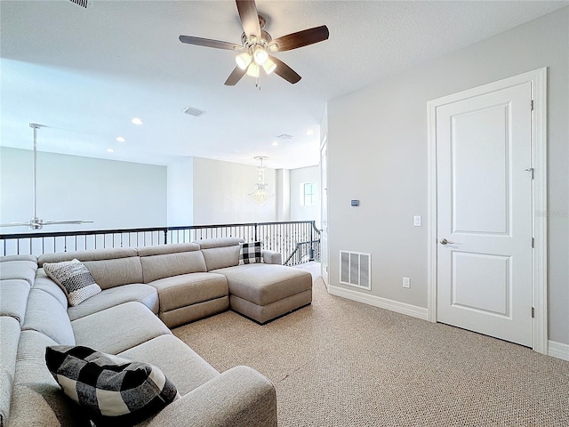 living room with ceiling fan and carpet