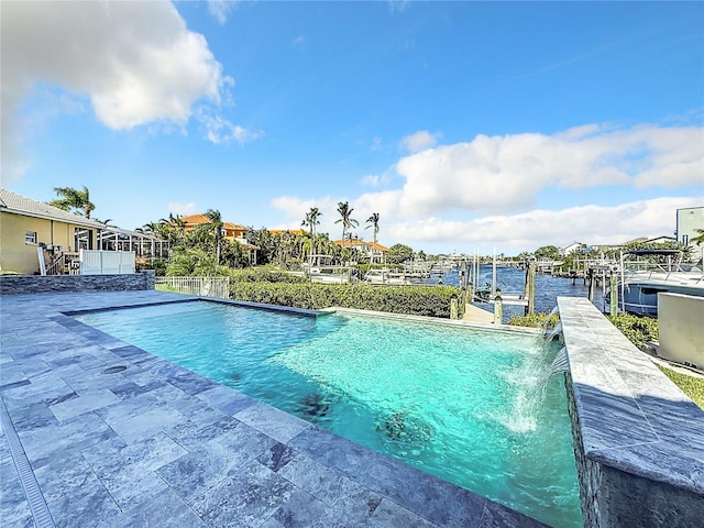 view of swimming pool with a patio, pool water feature, and a water view