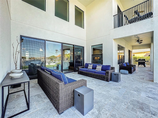 view of patio / terrace featuring a balcony, outdoor lounge area, and ceiling fan