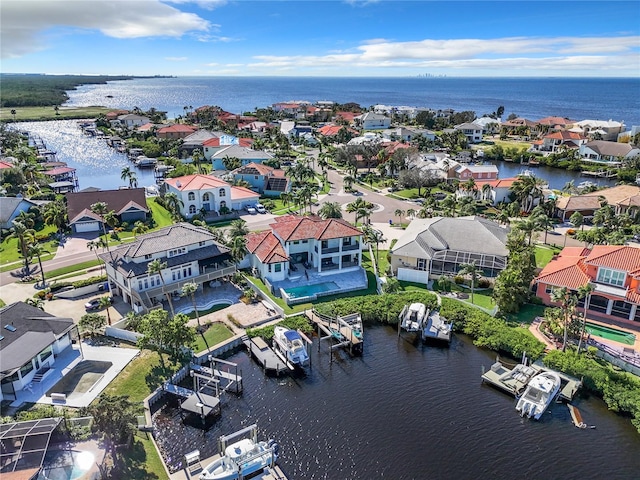 birds eye view of property with a water view