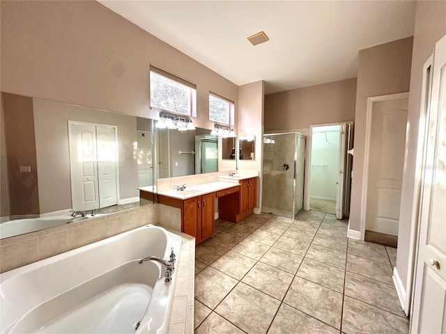 bathroom with vanity, plus walk in shower, and tile patterned flooring