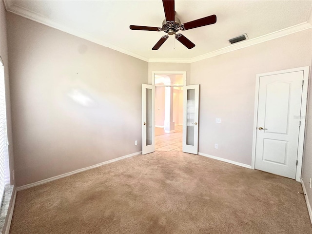 unfurnished bedroom featuring light carpet, ornamental molding, and ceiling fan