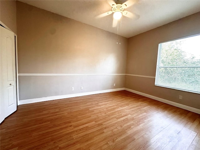 empty room featuring ceiling fan and hardwood / wood-style flooring