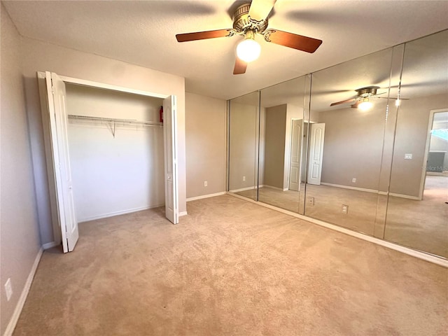 unfurnished bedroom featuring carpet floors, a ceiling fan, and baseboards