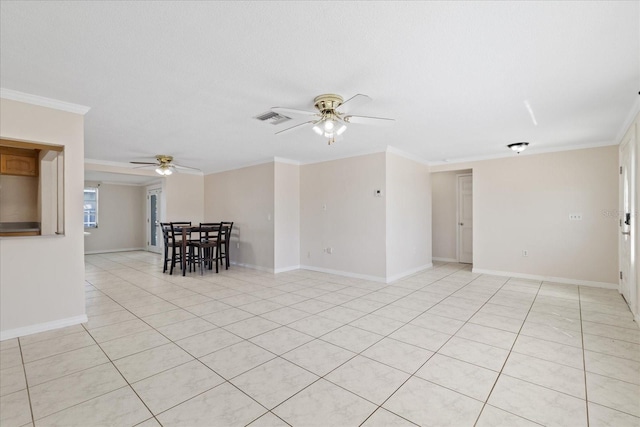 tiled spare room featuring ornamental molding and ceiling fan