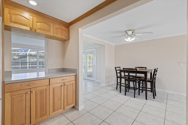 kitchen with ornamental molding, light tile patterned flooring, and ceiling fan