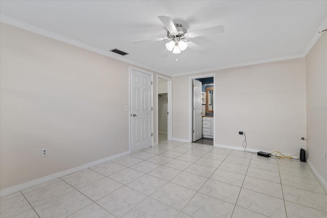 empty room featuring crown molding, light tile patterned flooring, and ceiling fan