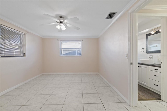 unfurnished room with sink, crown molding, light tile patterned flooring, and ceiling fan