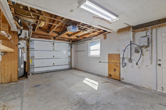 garage with a garage door opener and electric water heater