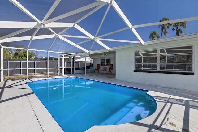 view of pool with a patio area and glass enclosure