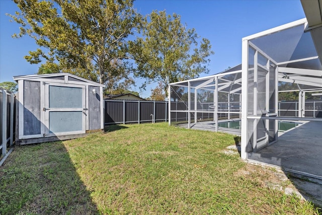 view of yard with a patio, a storage shed, a lanai, and a fenced in pool