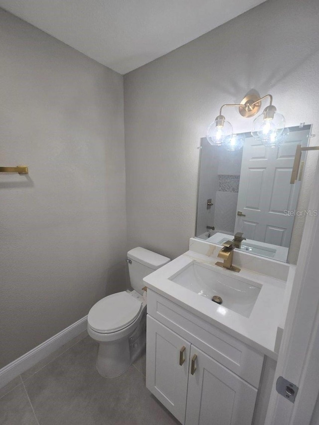 bathroom with vanity, toilet, and tile patterned flooring