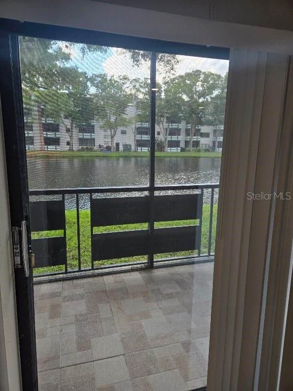 doorway to outside featuring a water view