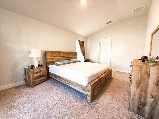 carpeted bedroom featuring lofted ceiling