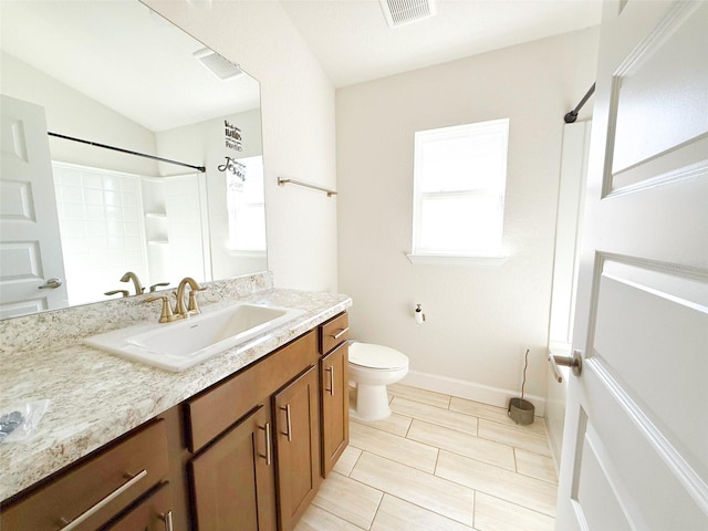 bathroom with lofted ceiling, vanity, a shower, and toilet