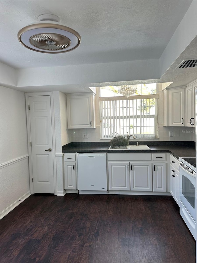 kitchen with dark hardwood / wood-style floors, sink, white cabinets, white appliances, and tasteful backsplash