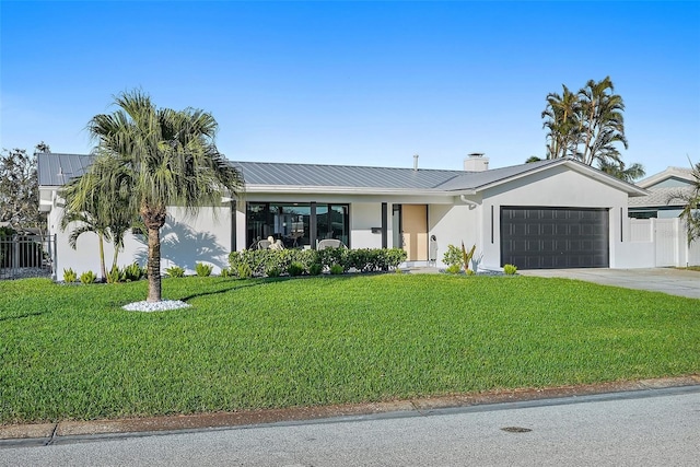 ranch-style house featuring a front yard and a garage