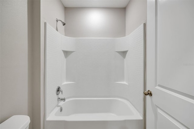 bathroom with shower / bathtub combination and toilet