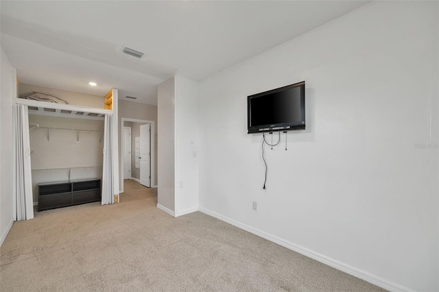 unfurnished bedroom with carpet flooring and a closet