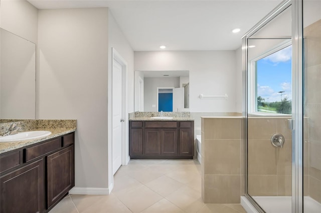 bathroom with vanity, tile patterned floors, and a shower with door