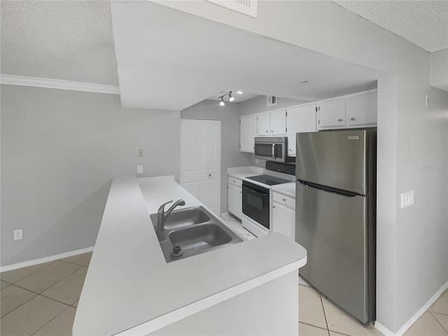 kitchen featuring sink, light tile patterned flooring, a textured ceiling, white cabinetry, and stainless steel appliances