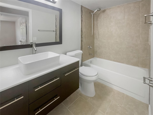 full bathroom with tiled shower / bath, vanity, toilet, and tile patterned flooring