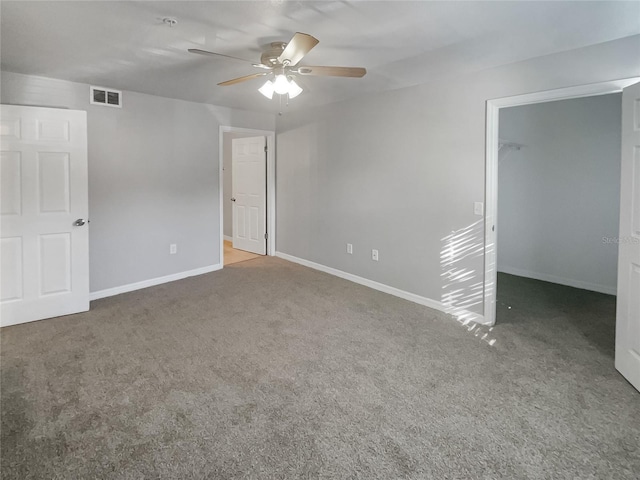 carpeted spare room with ceiling fan