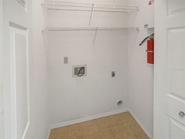 clothes washing area with electric dryer hookup and tile patterned floors