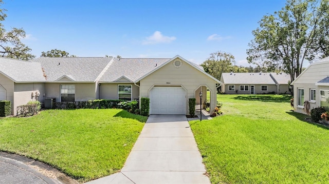 ranch-style home with cooling unit, a front lawn, and a garage