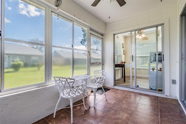 sunroom featuring ceiling fan