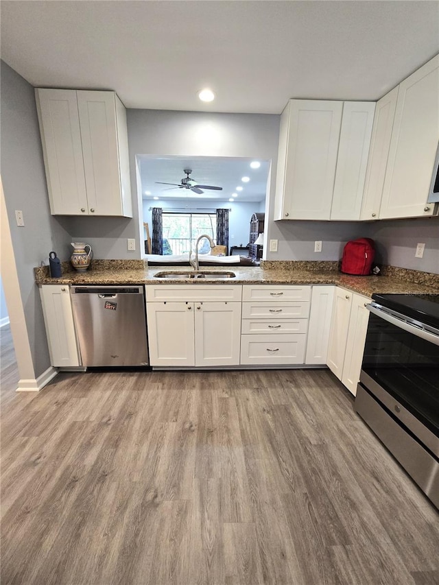 kitchen with sink, white cabinets, and appliances with stainless steel finishes