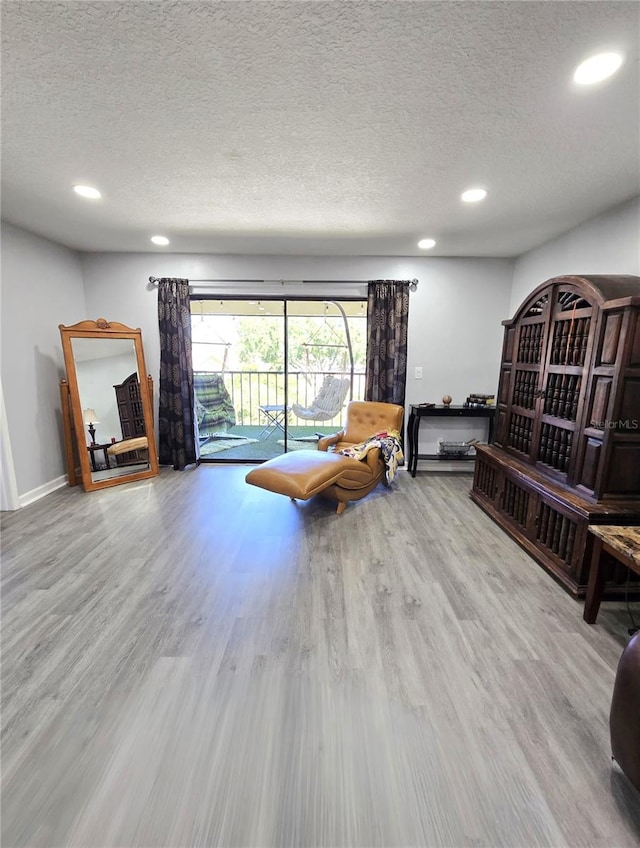 living room with hardwood / wood-style flooring and a textured ceiling