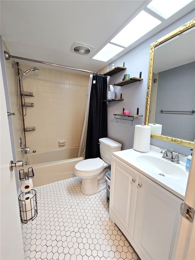 full bathroom with toilet, a skylight, shower / tub combo, and vanity