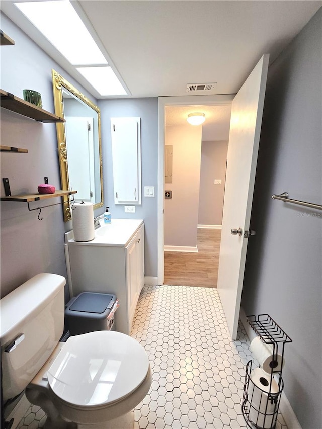 bathroom featuring toilet and vanity