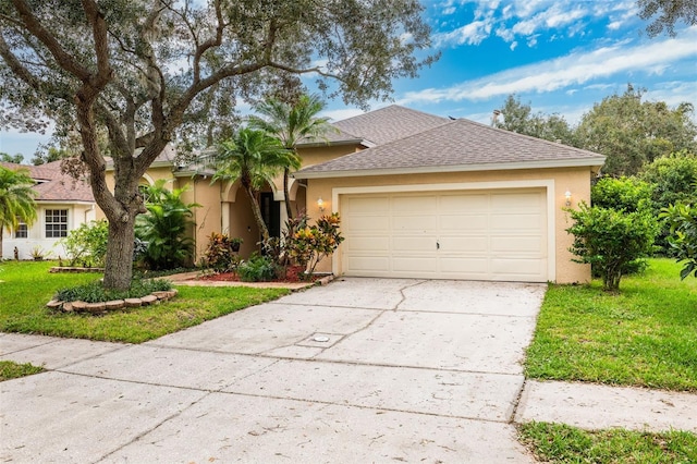 view of front of house featuring a front lawn and a garage