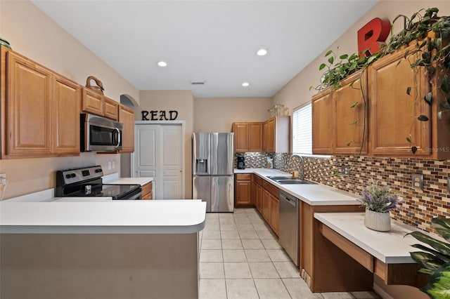 kitchen featuring light tile patterned floors, appliances with stainless steel finishes, sink, and backsplash