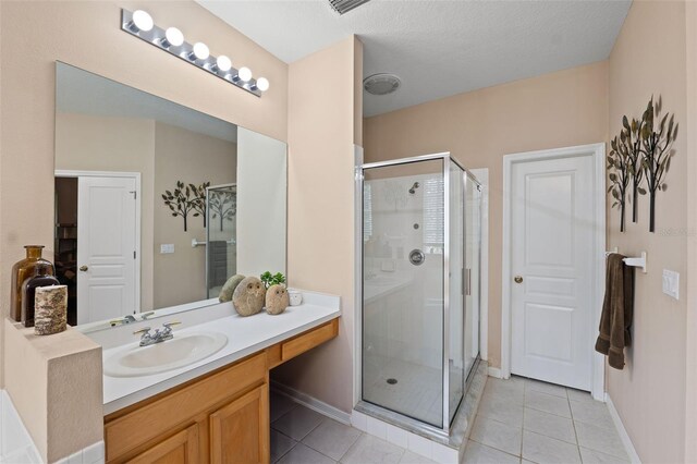 bathroom with vanity, an enclosed shower, and tile patterned floors