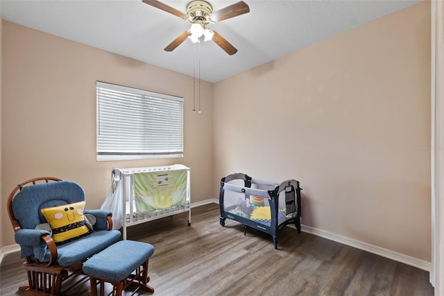 living area featuring hardwood / wood-style flooring and ceiling fan