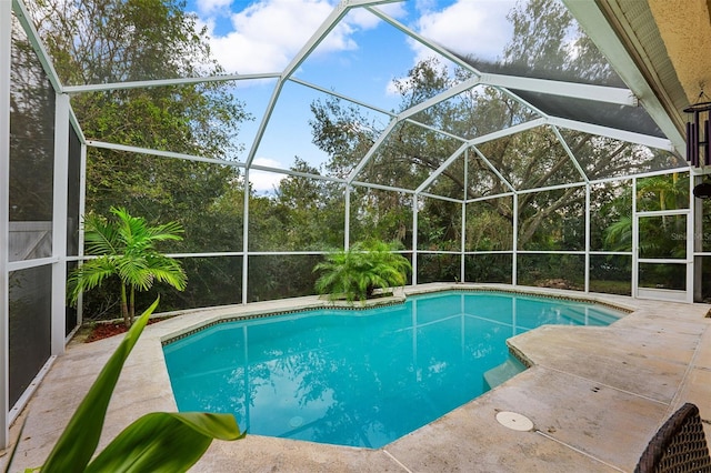 view of pool featuring a patio and glass enclosure