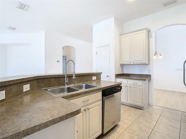 kitchen featuring sink, light tile patterned flooring, decorative light fixtures, and dishwasher