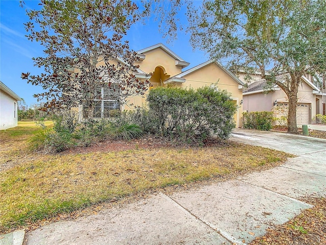 view of property hidden behind natural elements with a garage