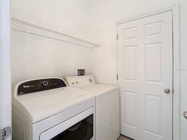 clothes washing area featuring washing machine and clothes dryer