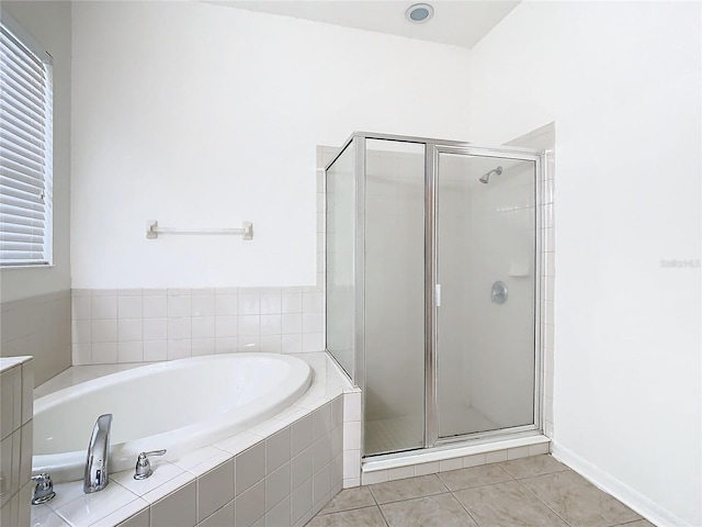 bathroom featuring vanity, tile patterned floors, and plus walk in shower