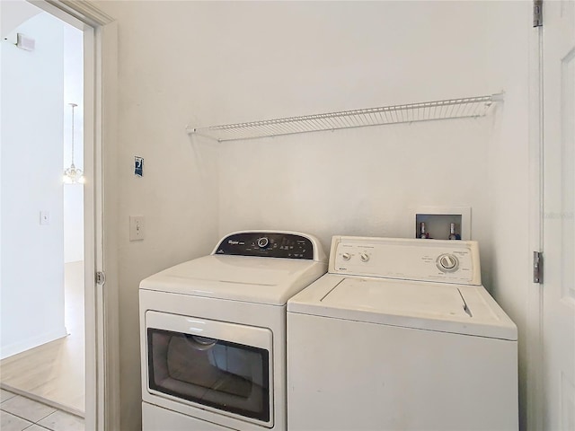 washroom featuring light tile patterned floors and washing machine and dryer