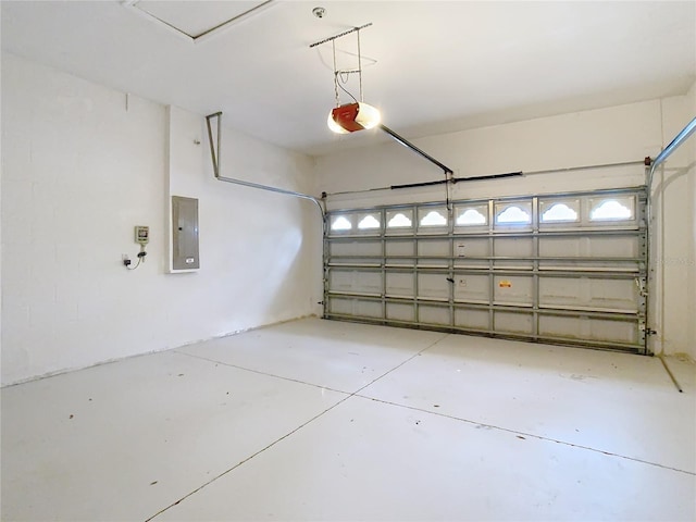 garage featuring electric panel and a garage door opener