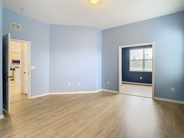 spare room with light wood-type flooring