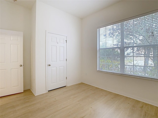 unfurnished bedroom with light hardwood / wood-style floors and a closet